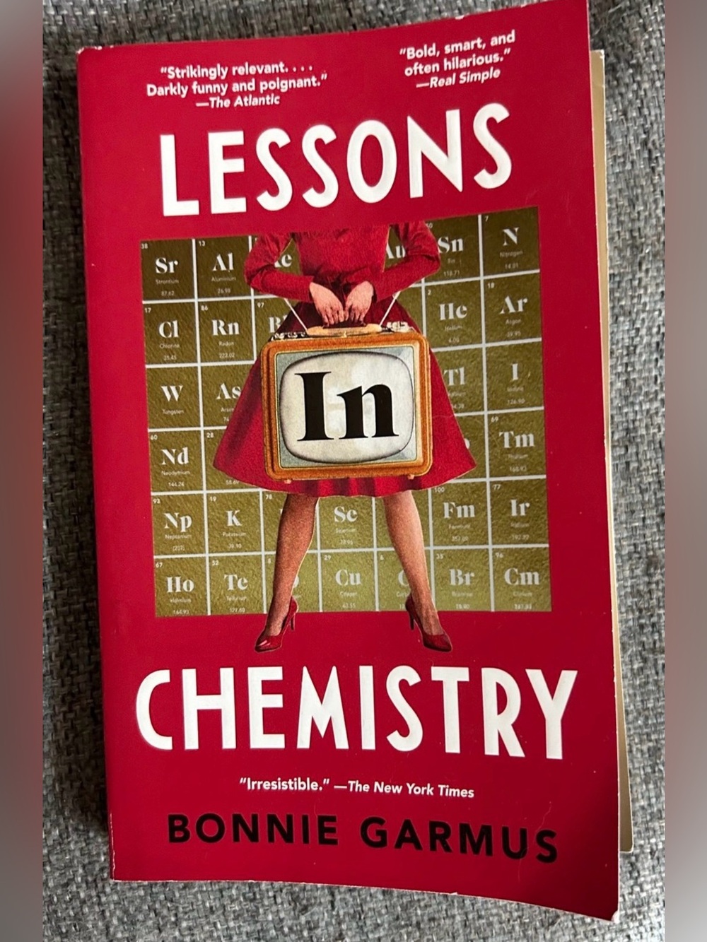 Lessons in Chemistry — Red Paperback by Bonnie Garmus